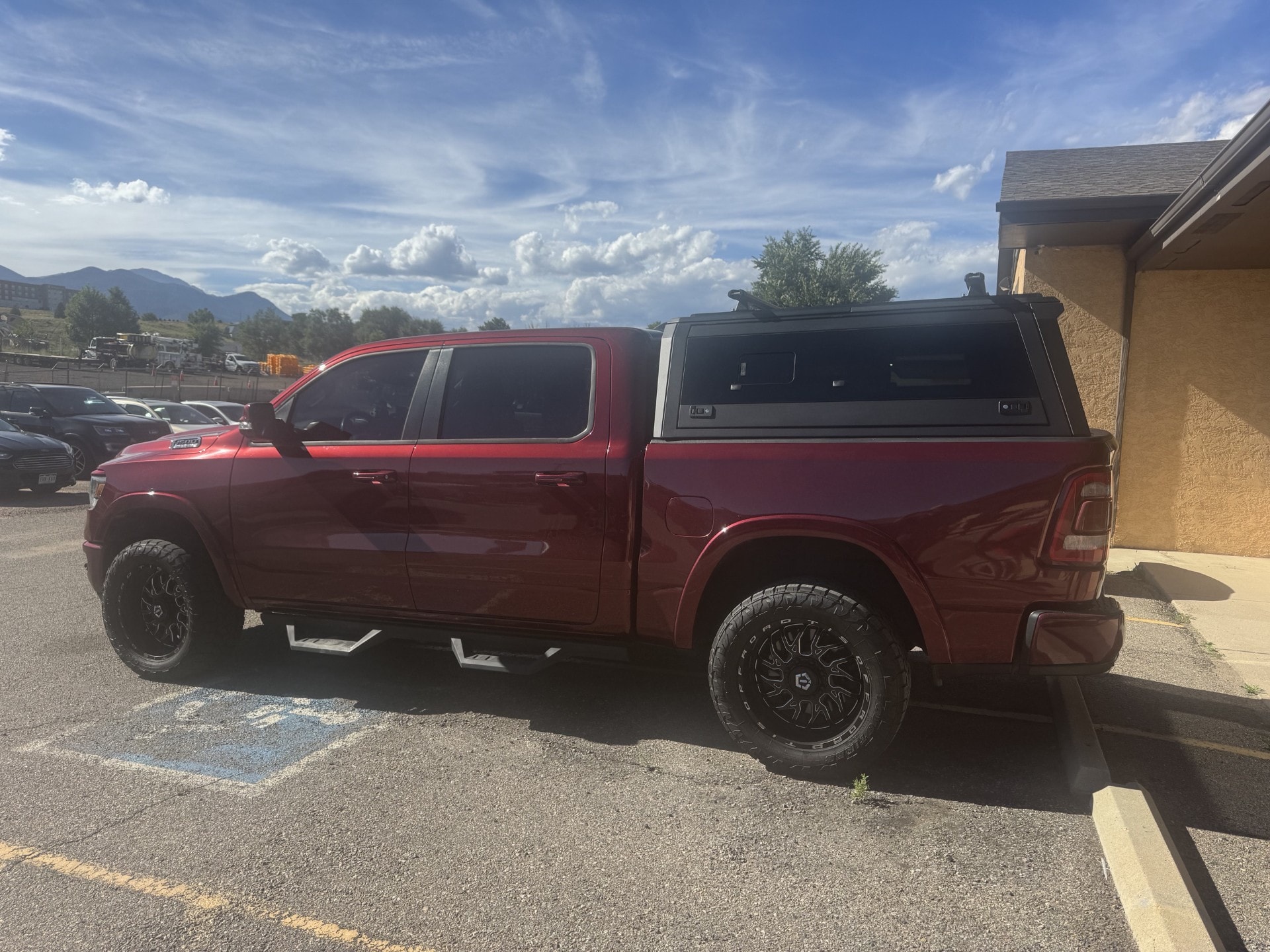 Red Ram 1500 with a Peakline aluminum truck cap and roof bars
