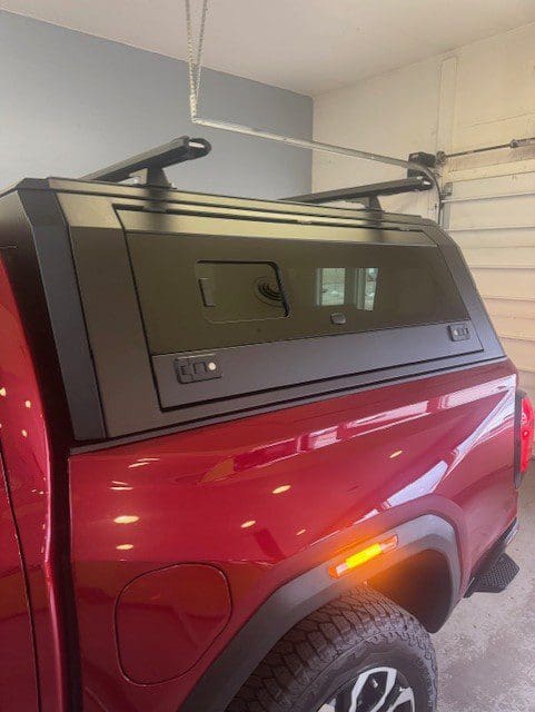 Close view of black topper with side window on a red GMC Canyon