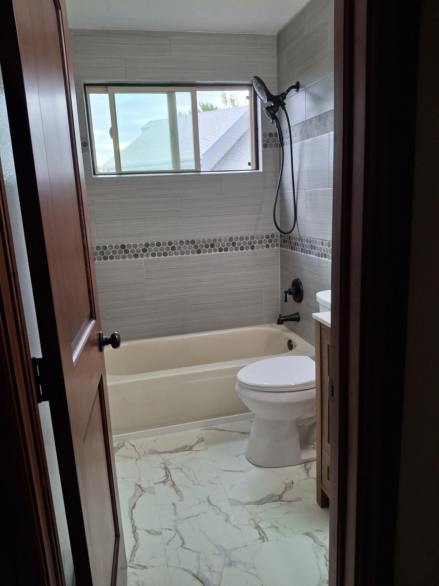 Finished bathroom with tile surround and new flooring