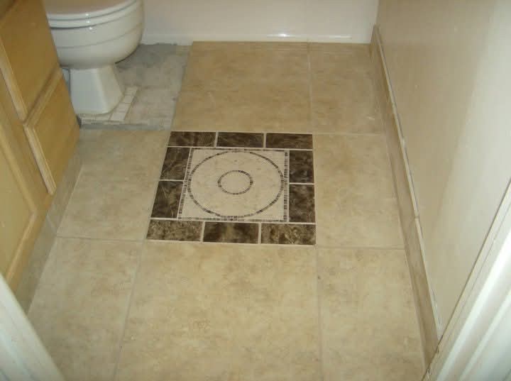 Decorative tile detail in a bathroom floor.