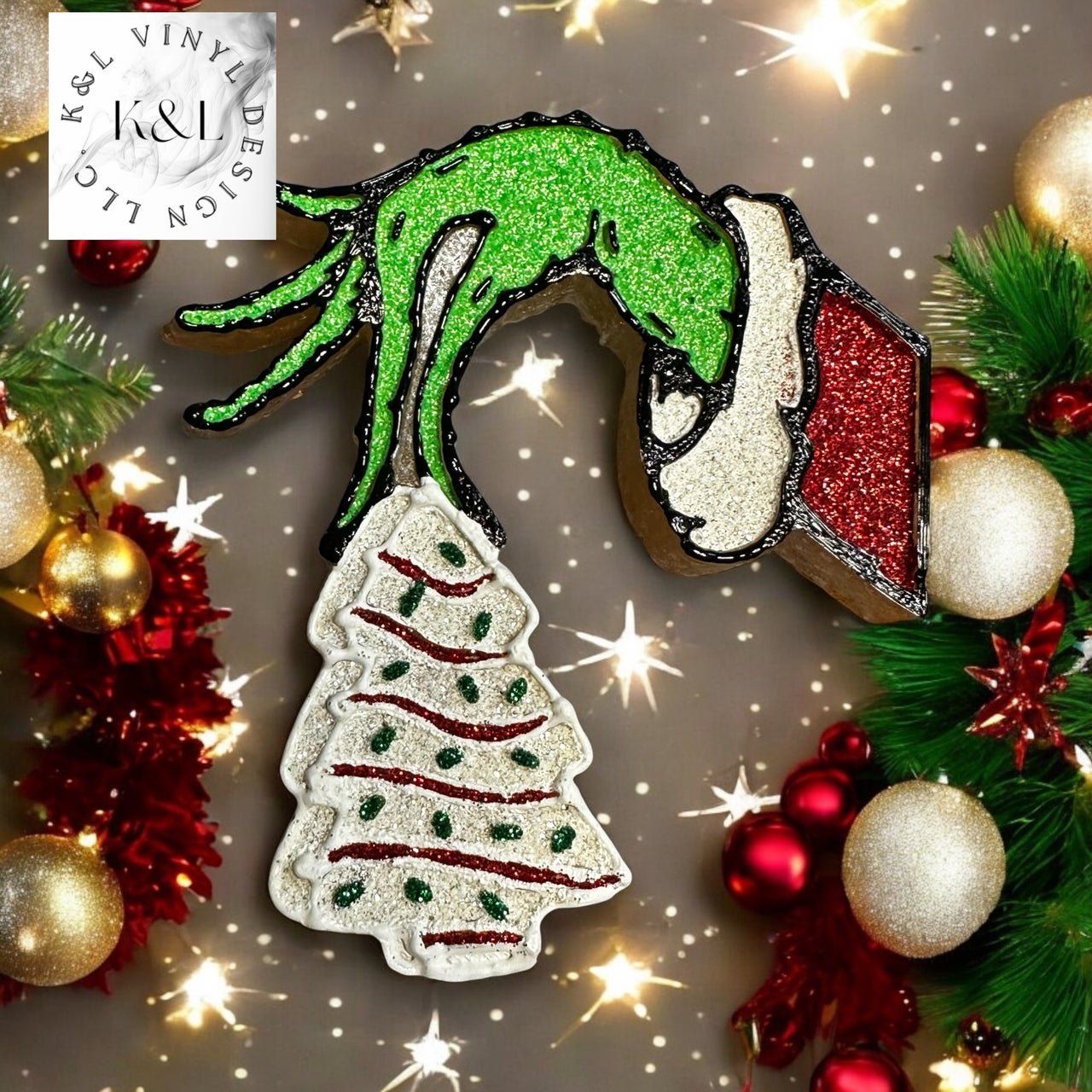 Grinch hand holding snack cake