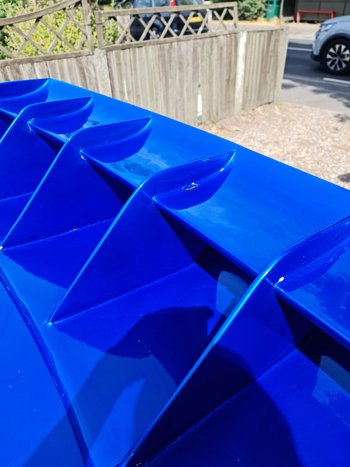 Reflections across the Subaru blue rear spoiler and boot