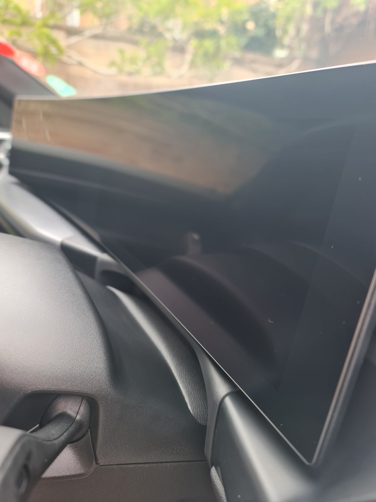 BMW interior door trim after detailing, showing the cleaned panel and handle