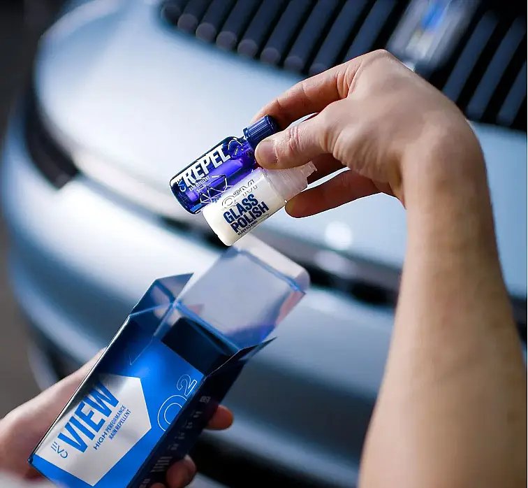 Gyeon Q2 View glass coating and glass polish products beside a vehicle