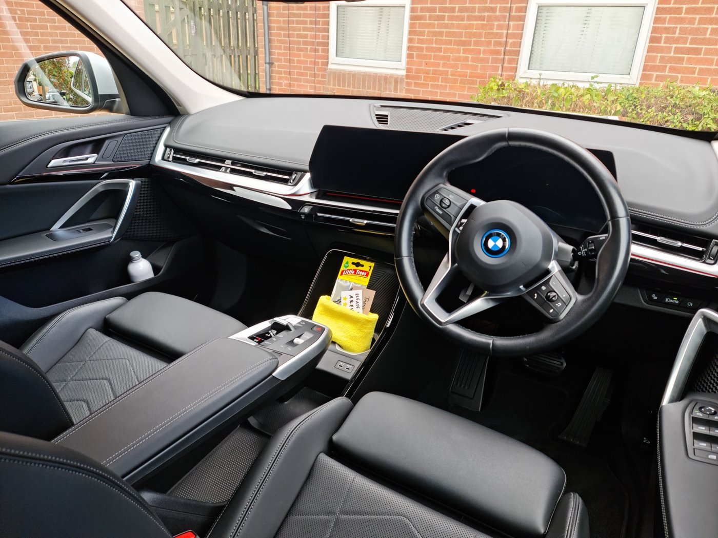 Clean BMW cabin with black leather seats and detailed dashboard