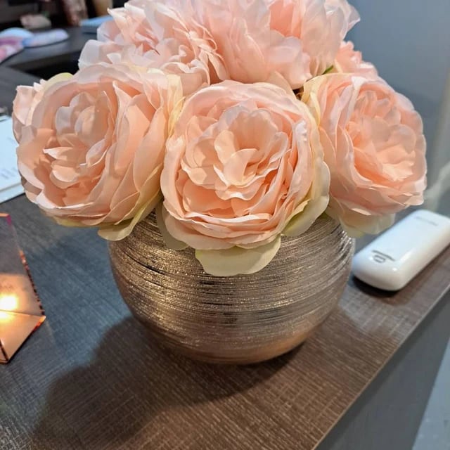Peach flower pens styled in a woven vase