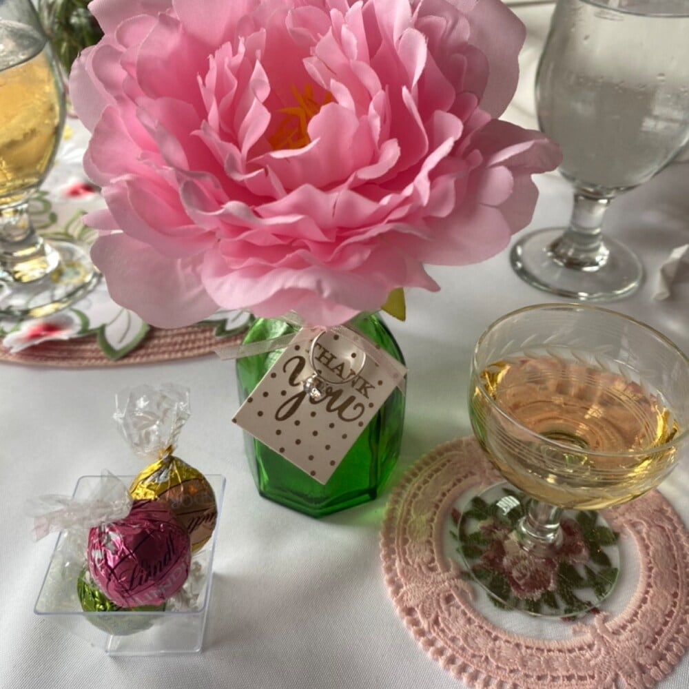 Pink flower pen beside a place setting