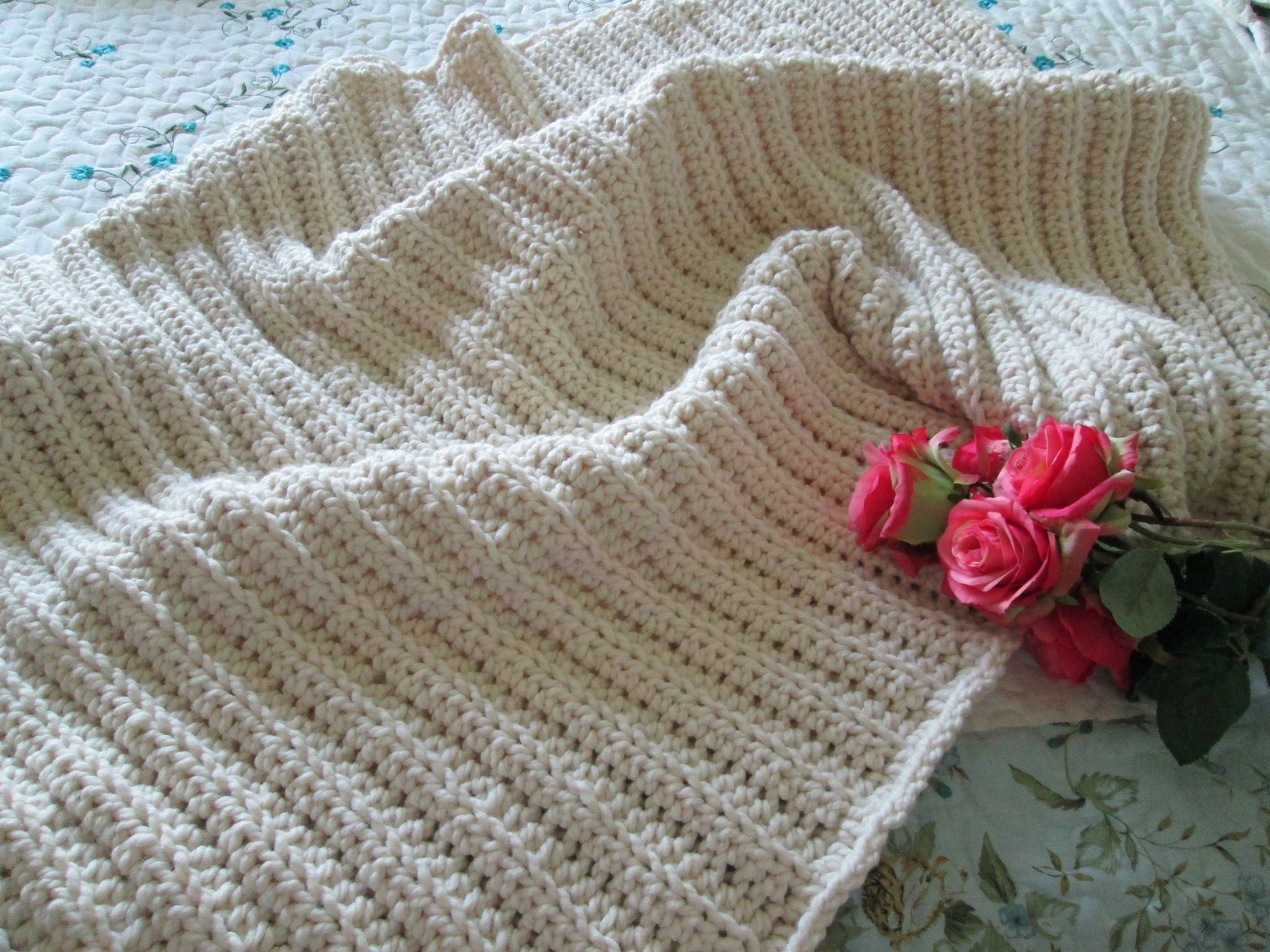 Hand-knit cream blanket with pink roses