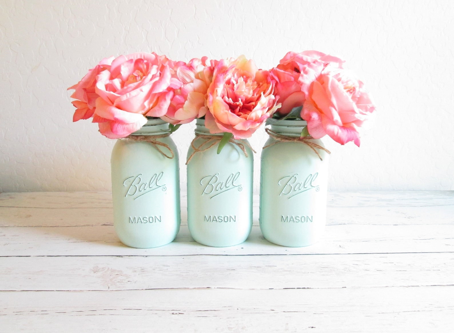 Hand-painted mint green mason jars arranged as colorful handmade decor