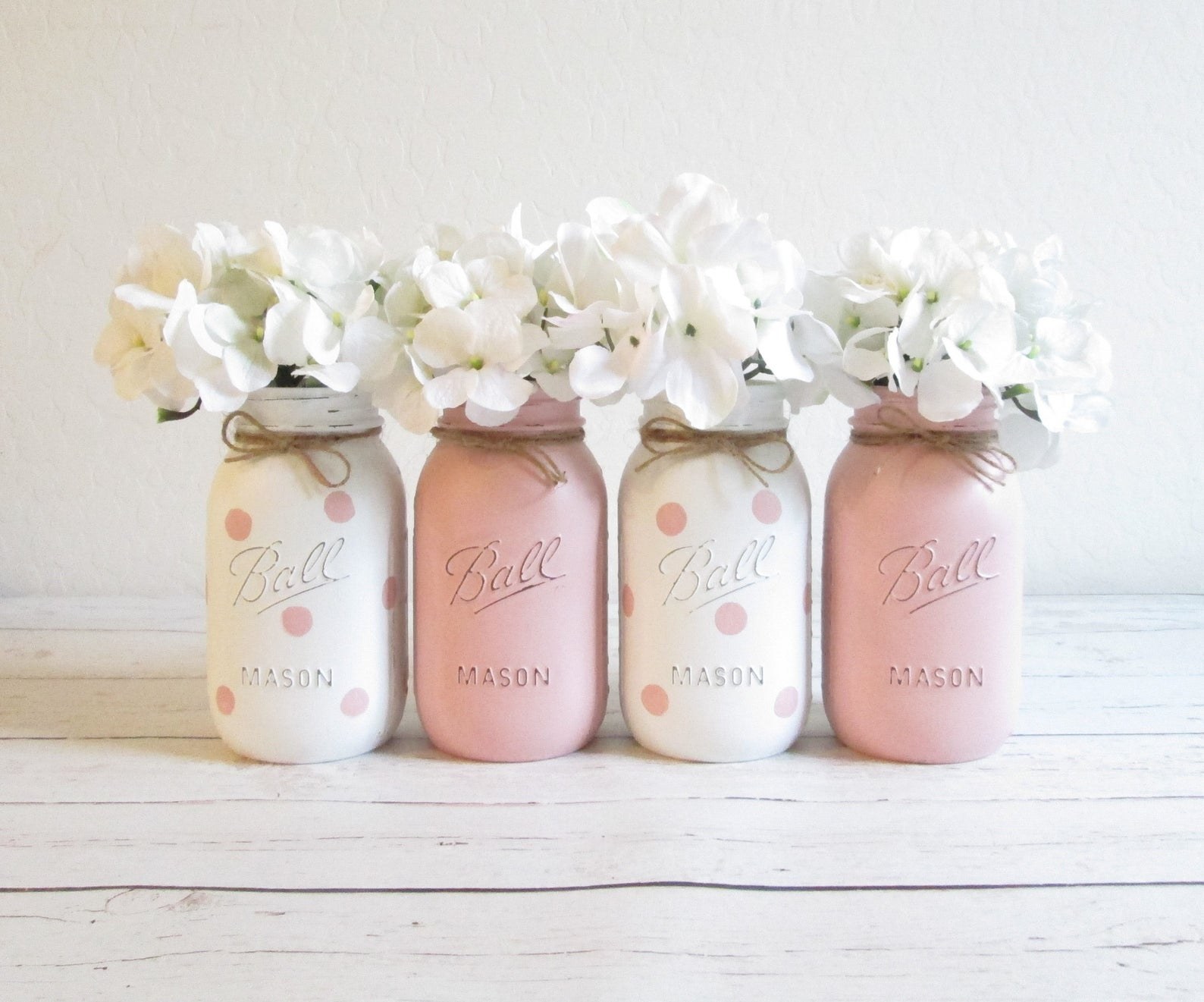 Set of four hand-painted pink and white mason jar centerpieces