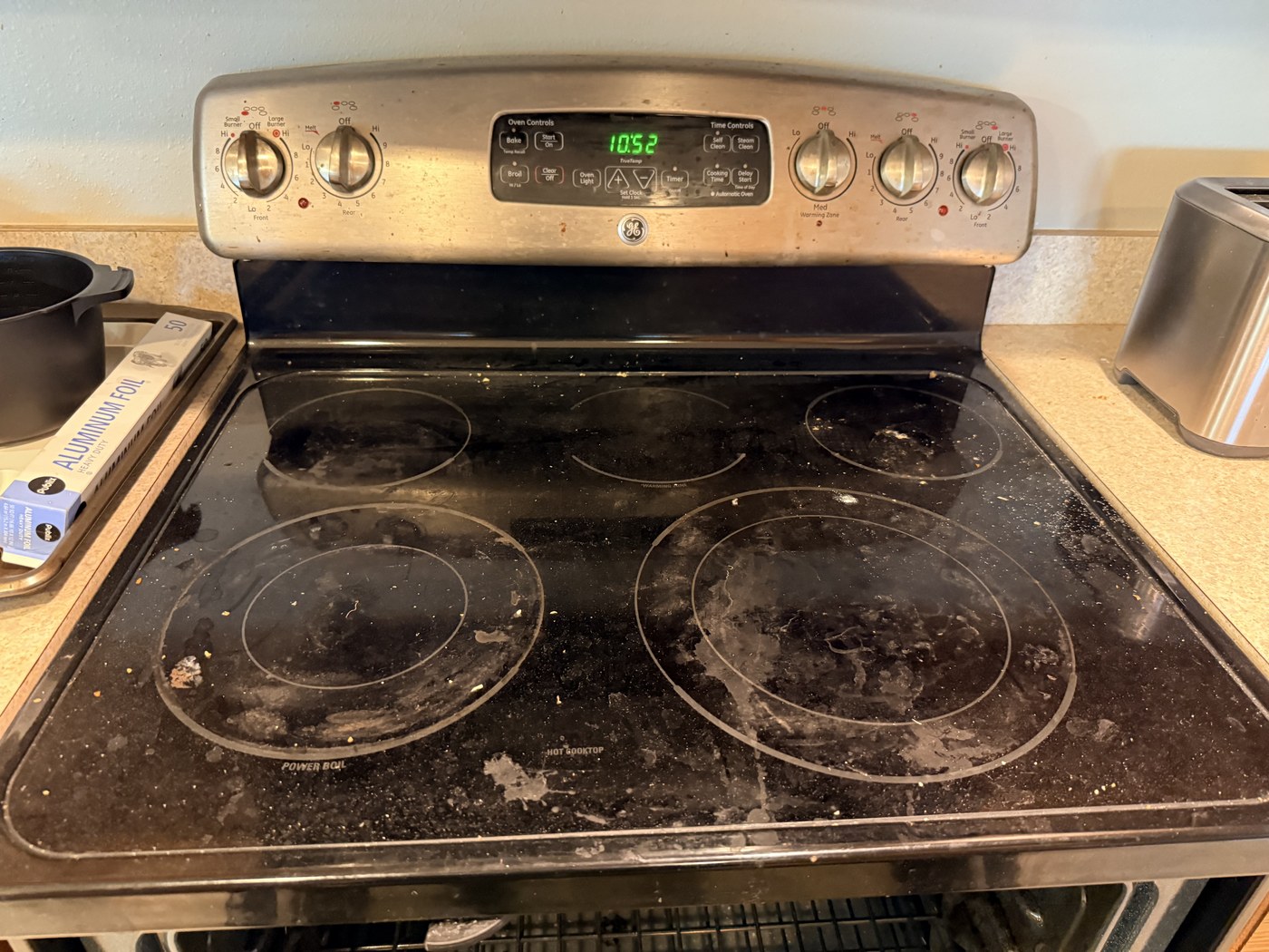 Glass stovetop before a professional deep clean