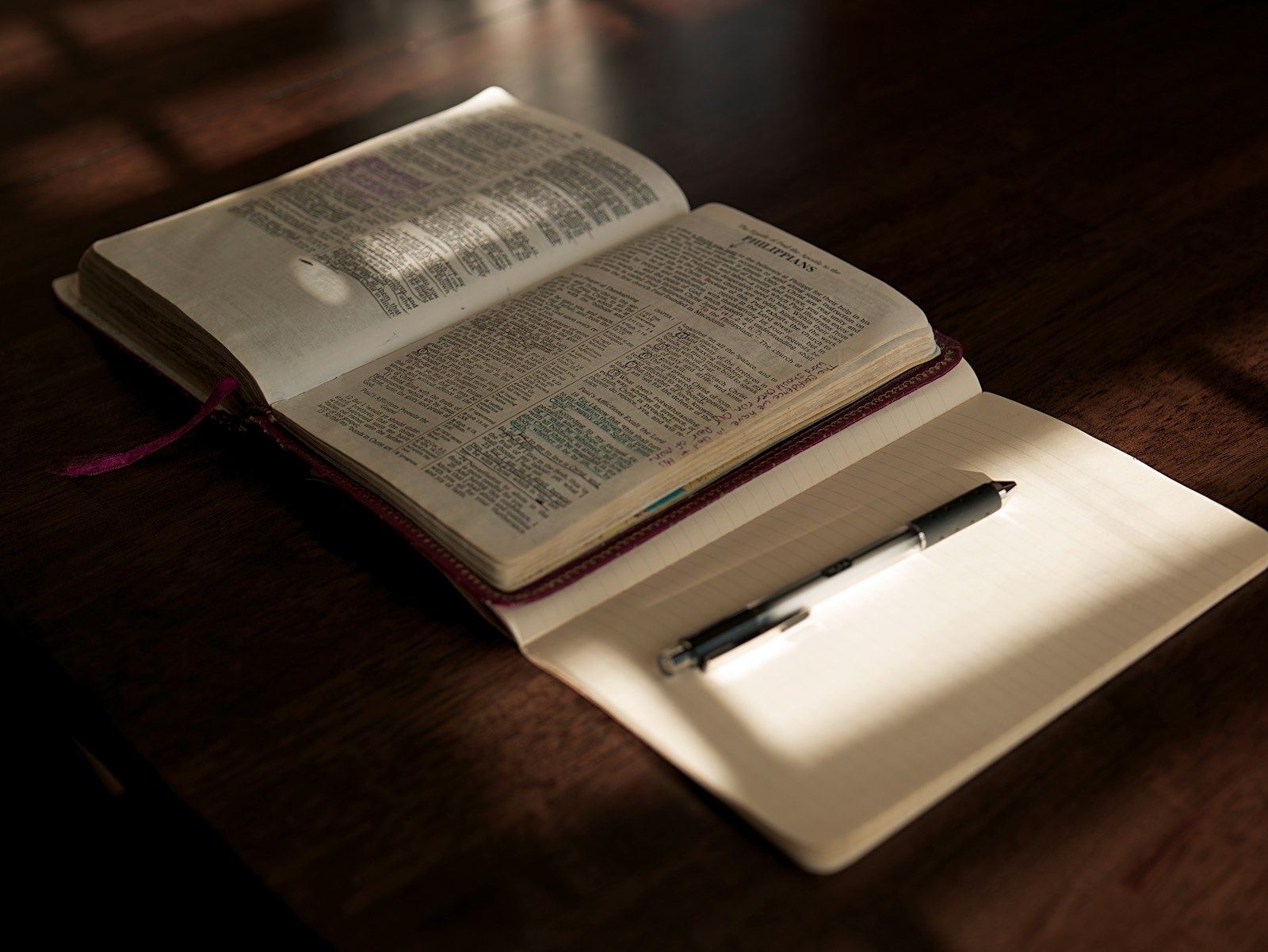 An open Bible, notebook, and pen arranged for a quiet time of reflection