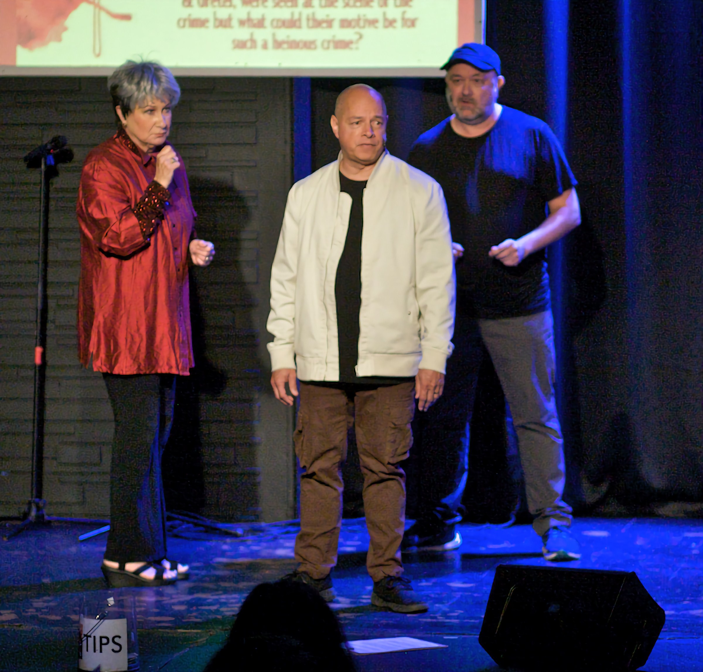 Cheryl King performing with two cast members onstage