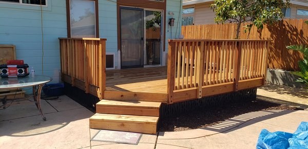 Completed redwood deck with railings from Heavenly Handy Construction's project gallery