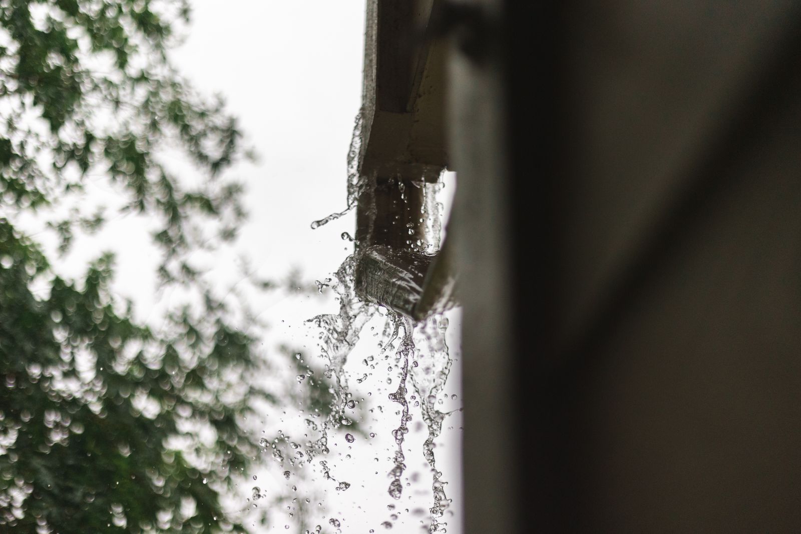 Rain droplets on a gutter joint and downspout connection