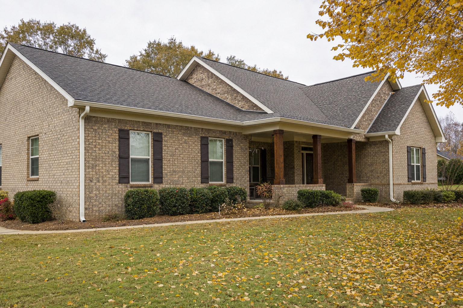 Brick North Mississippi home with white gutters and early fall leaves