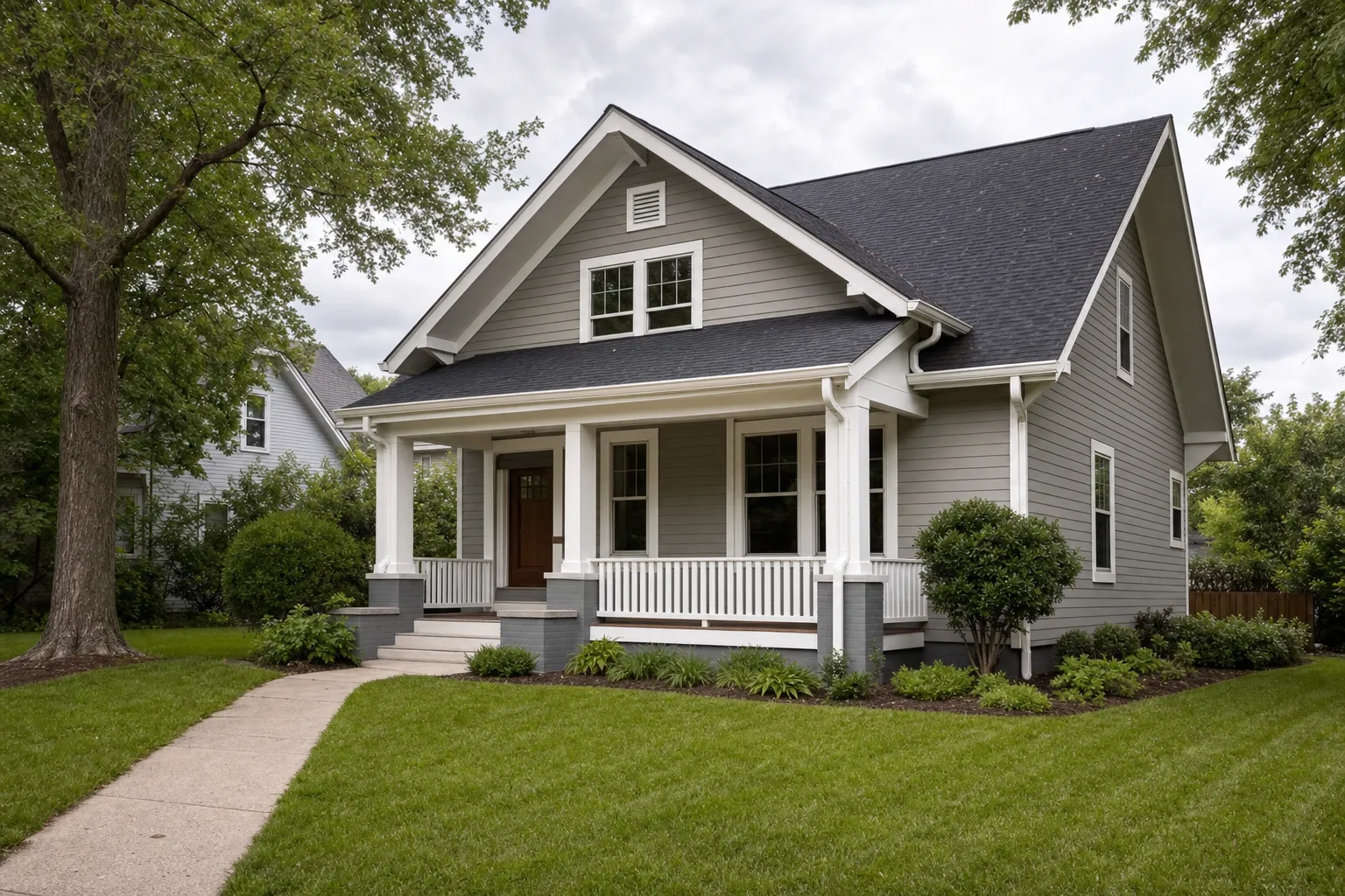 Well-kept single-family home with a front porch and clean gutters