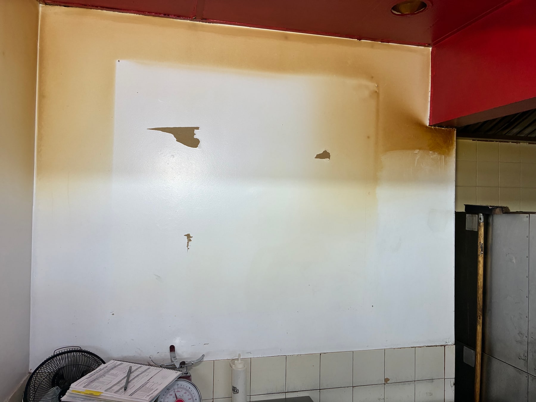Commercial kitchen wall before improvements at Barnes Crossing Mall