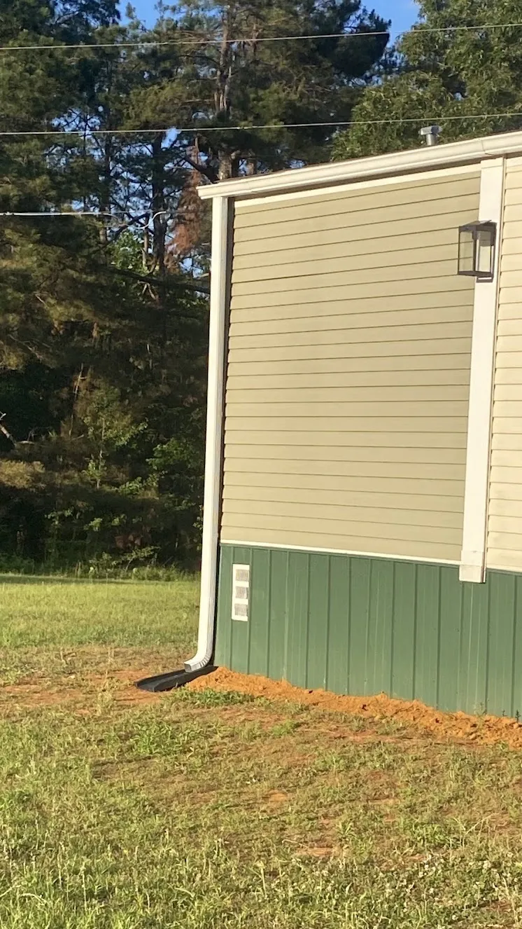 Completed gutter and downspout installation at a Ripley home