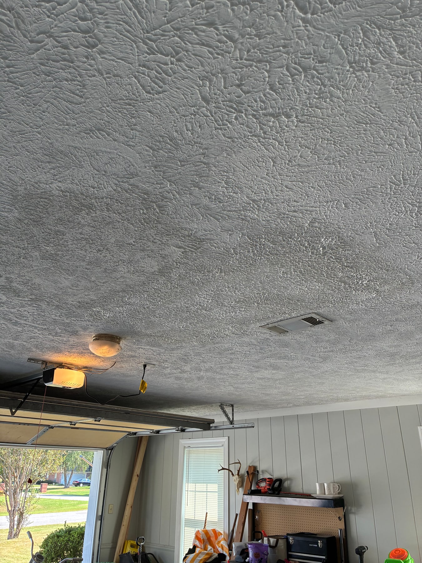 Repaired garage ceiling with restored textured finish in Tupelo
