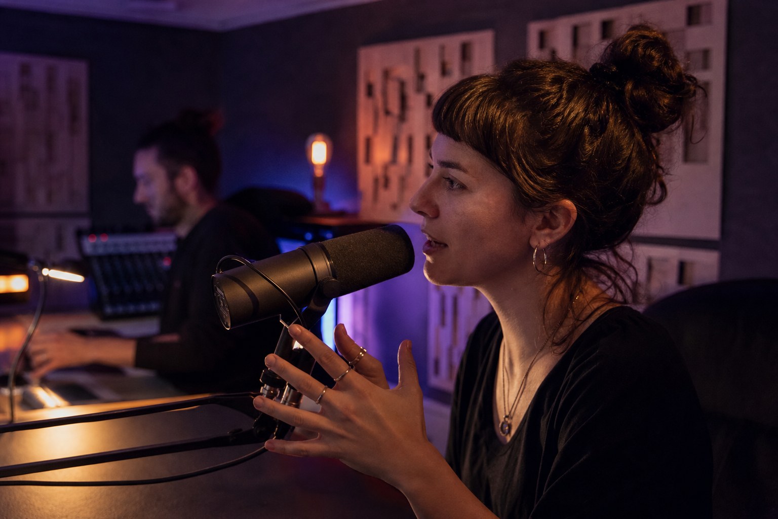 Independent artist recording a spoken introduction in a compact studio
