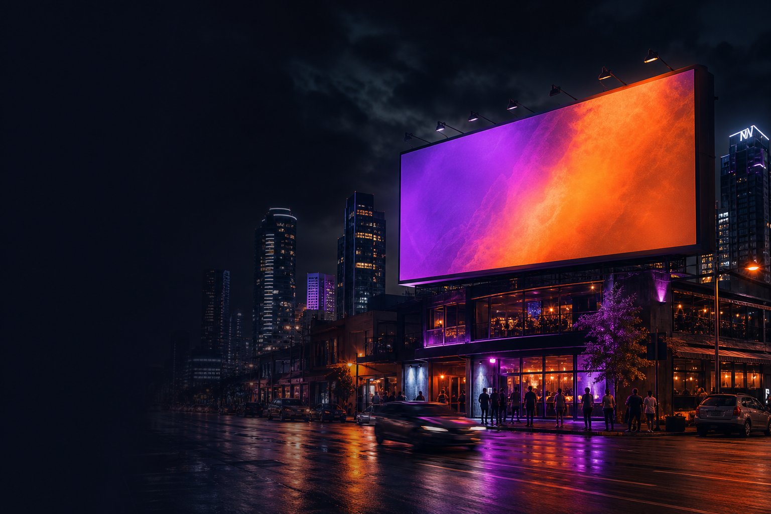 Digital billboard glowing above a city at night