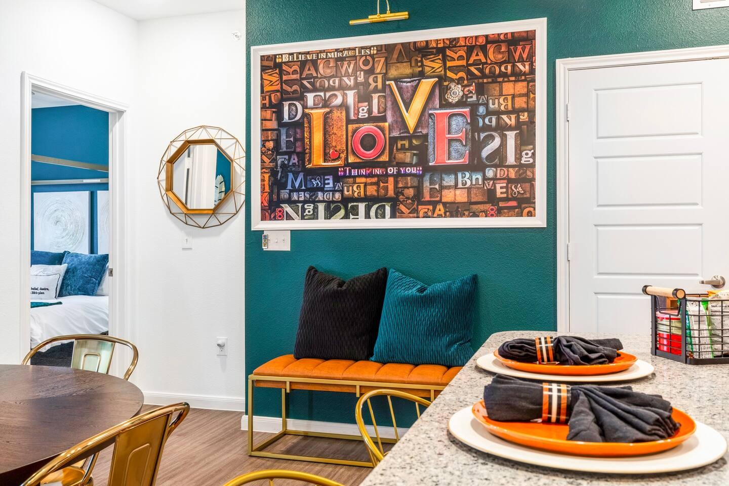 Dining area with colourful Love artwork on the wall