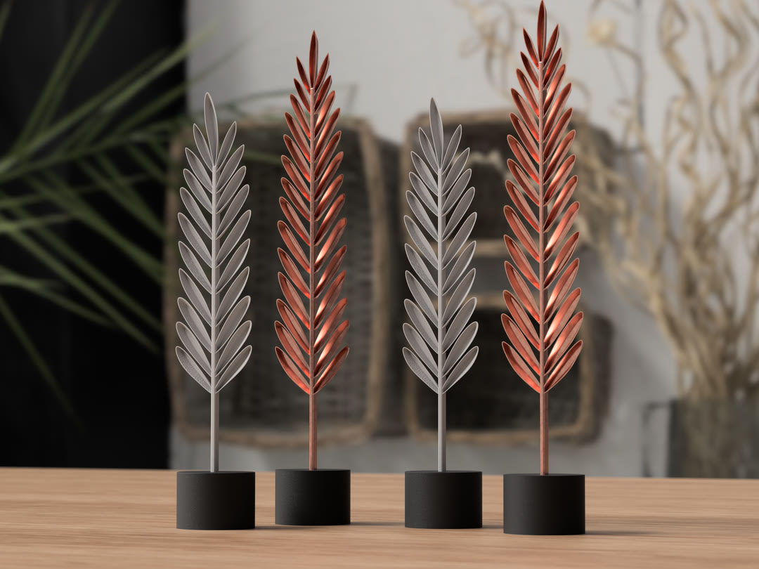Four sculptural leaf stems in black bases