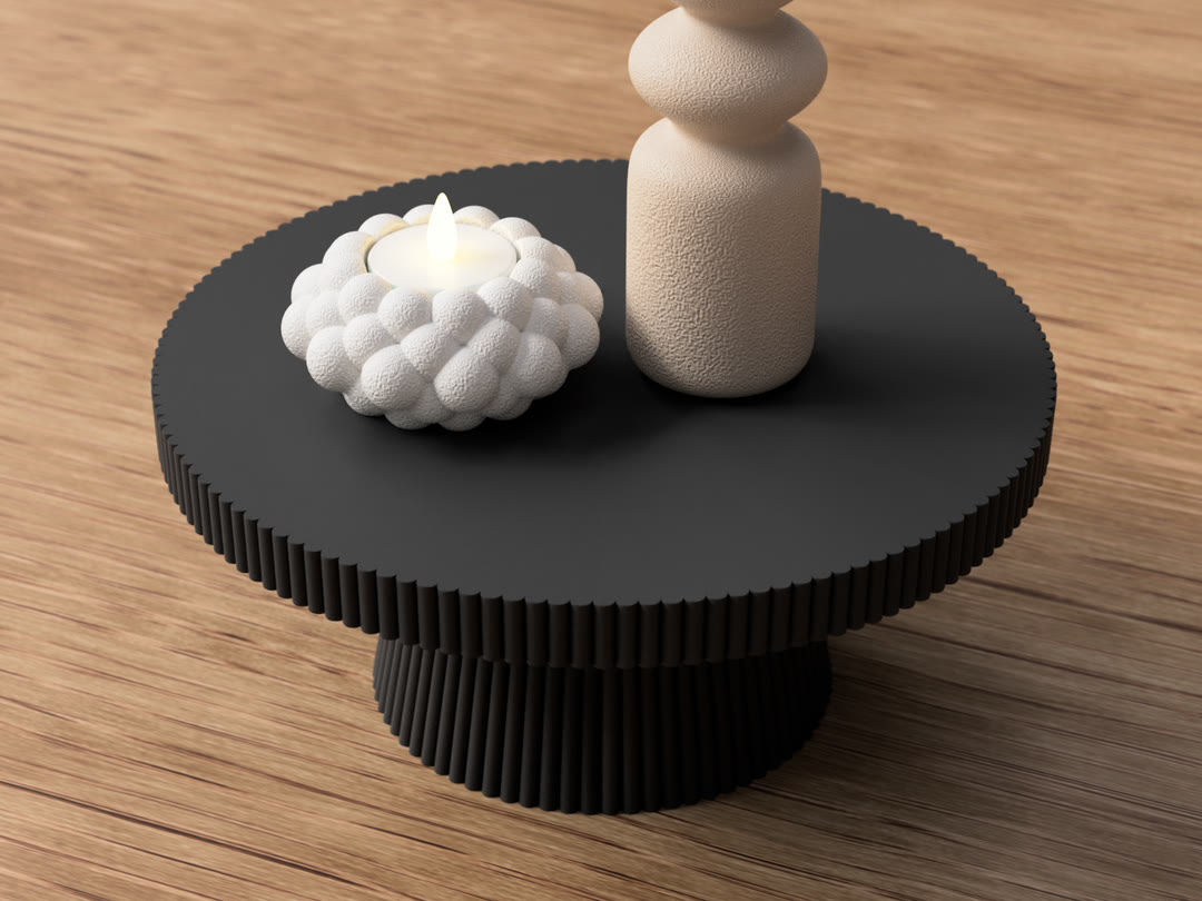 Textured bubble candle holder beside a sculptural vase
