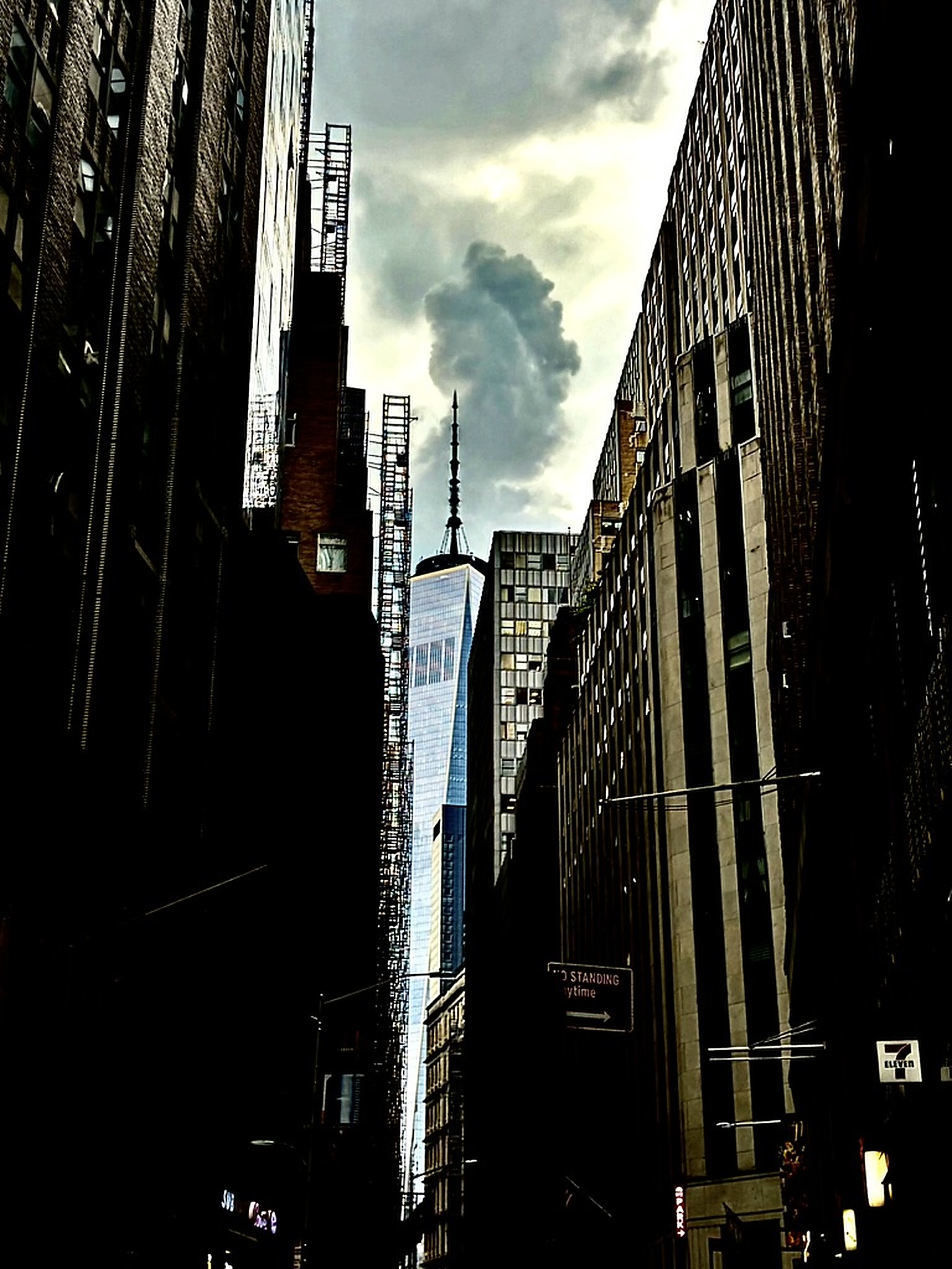 Skyscraper framed by city buildings, photographed in New York.