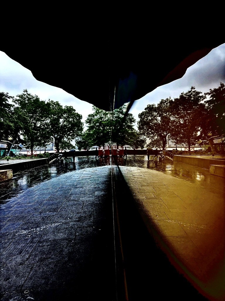 Memorial pool beneath a dark overhang