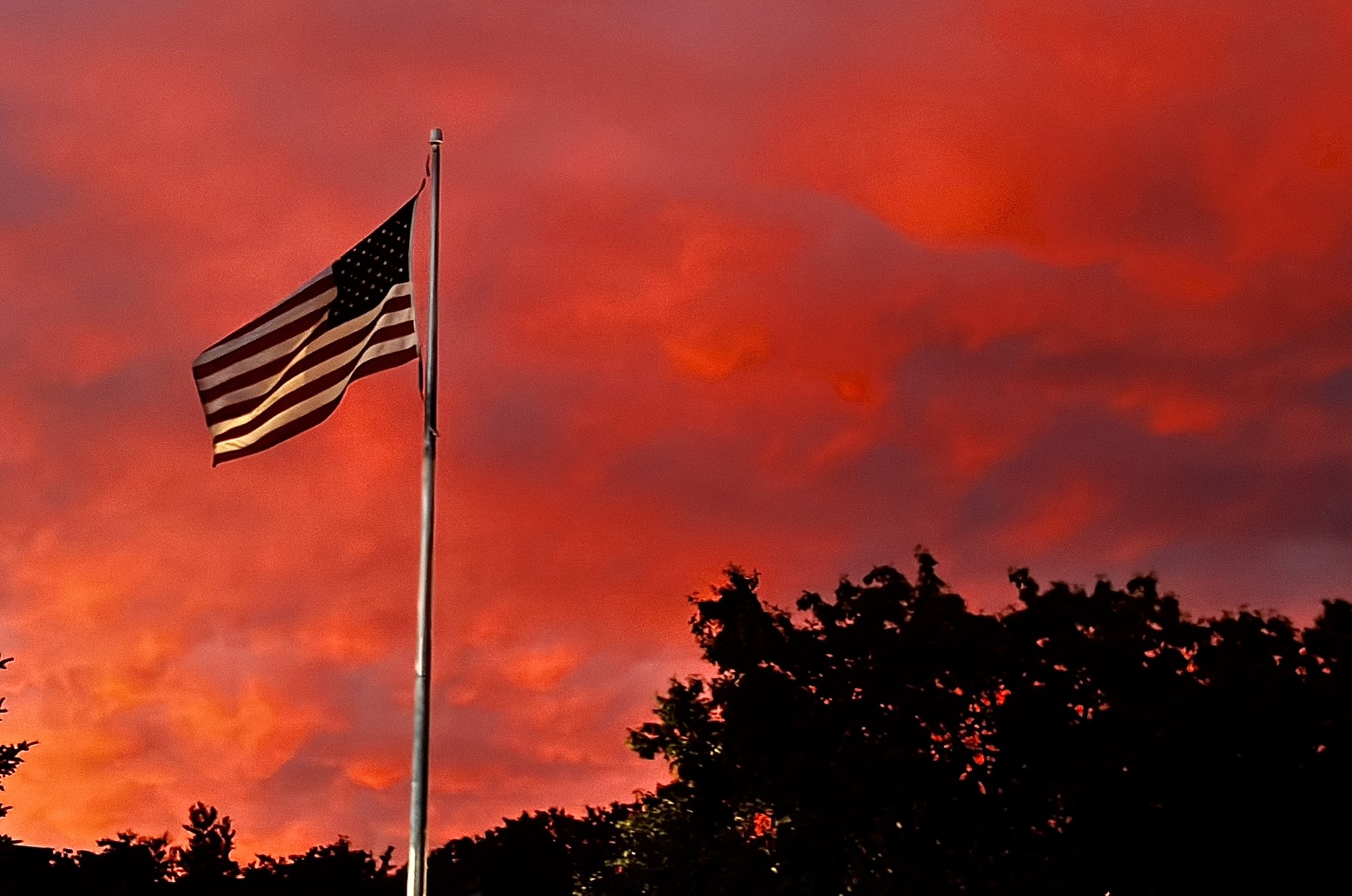 American flag against an orange sunset