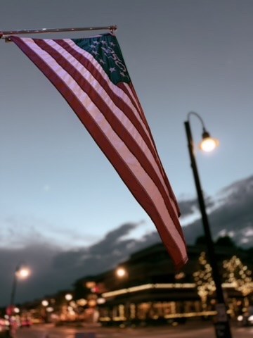 American flag and streetlight at dusk
