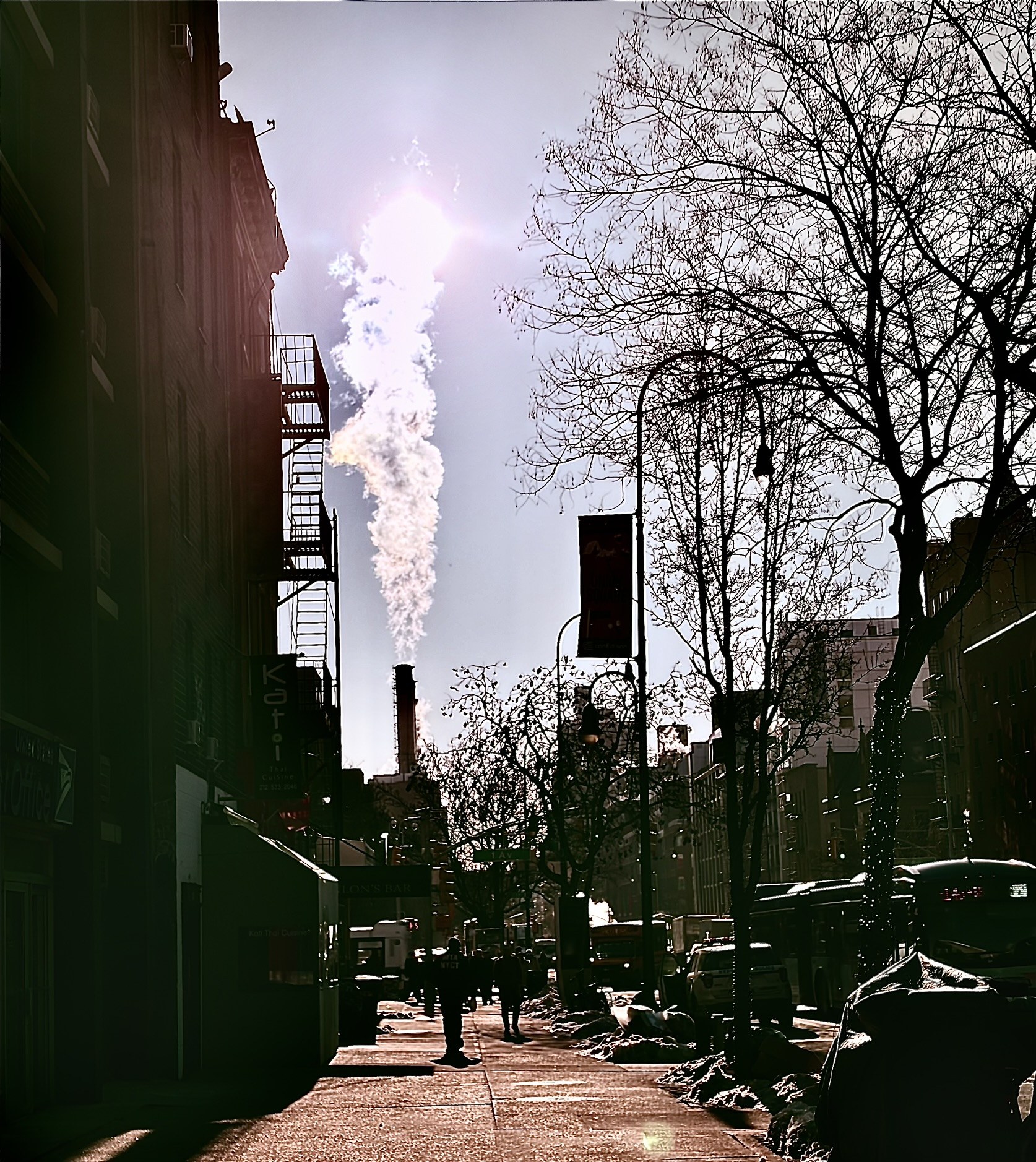 Sunlight and steam on a neighborhood street
