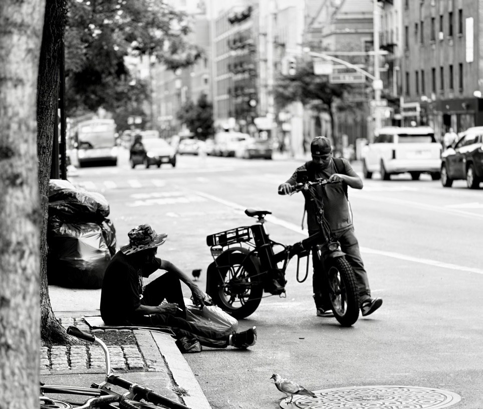 People and bicycles on a city sidewalk