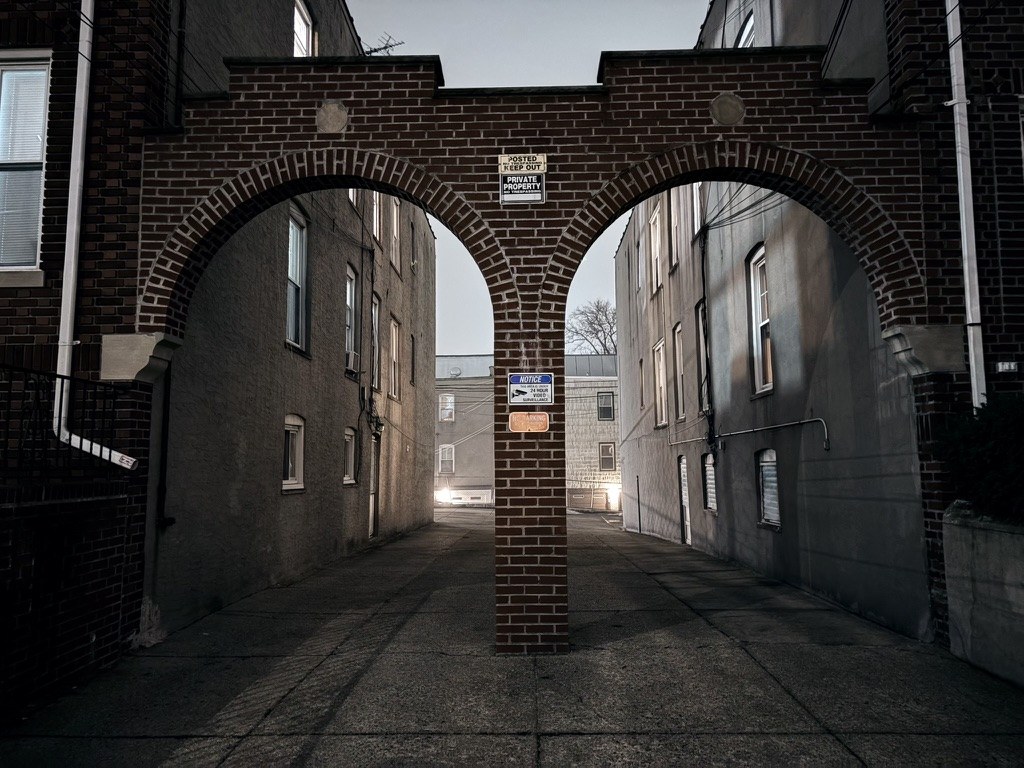 Brick archway framing an alley