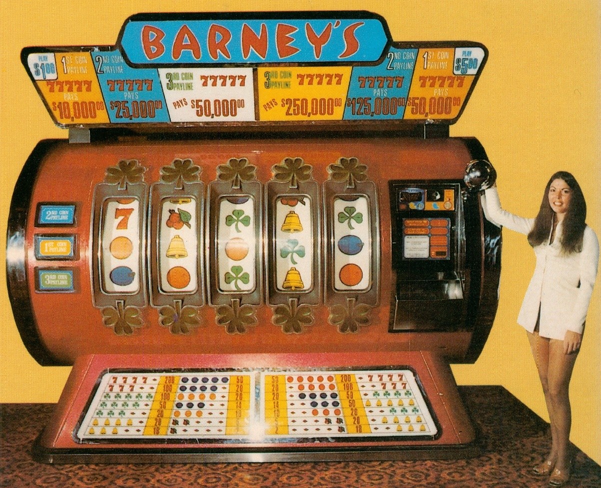 A vintage slot machine labeled 'Barney's' with three reels displaying symbols like 7s, bells, and fruits, alongside a woman in a white outfit standing beside it.