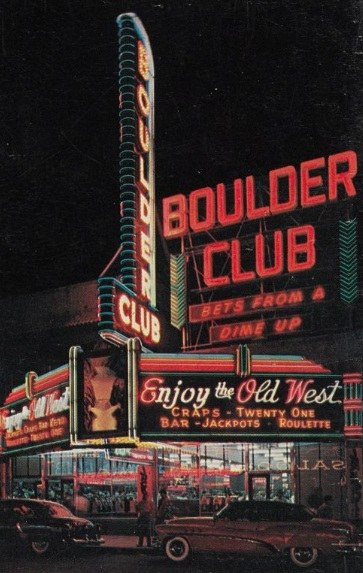 Neon sign of the Boulder Club, a casino featuring gambling games, with vibrant lights illuminating the building at night.