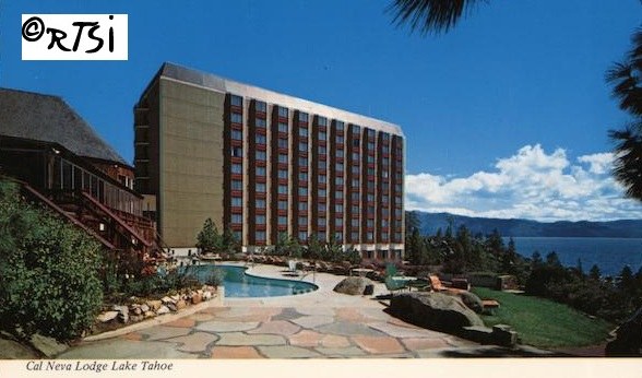 View of the Cal Neva Lodge at Lake Tahoe, featuring a tall hotel building beside a pool and landscaped grounds under a clear blue sky.