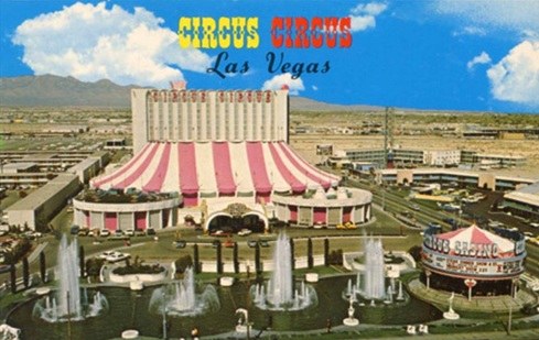 Aerial view of Circus Circus hotel and casino in Las Vegas, featuring its iconic striped tent roof and outdoor fountains.