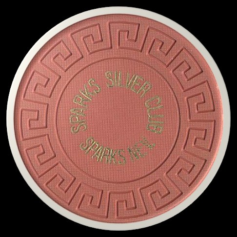 A round, embossed token with a textured surface featuring a Greek key design and the text 'SPARKS SILVER CLUB' and 'SPARKS, NEV.'