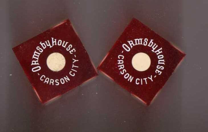 Two square red tokens featuring the text 'Ormsby House - Carson City' and a central white circle.