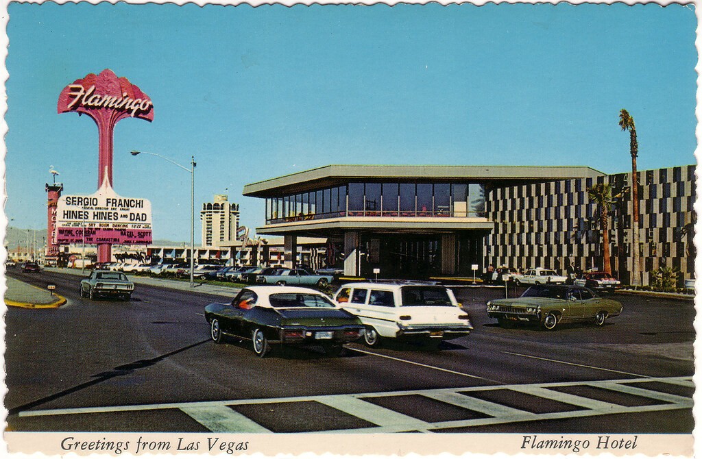 1960s Flamingo Hotel postcard showing the roadside sign, entrance, and cars outside.
