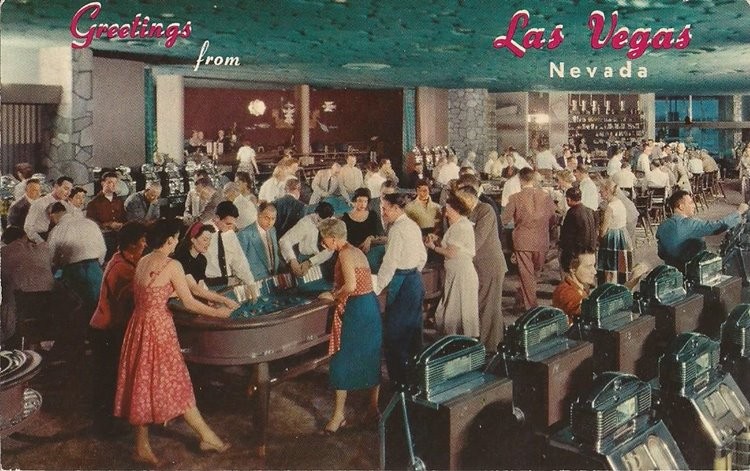 Color postcard showing gamblers, casino tables, and slot machines inside the Flamingo.