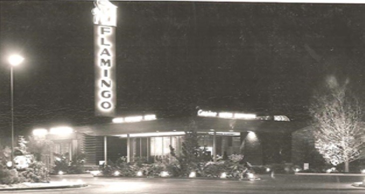 The Flamingo’s illuminated tower sign and entrance at night.