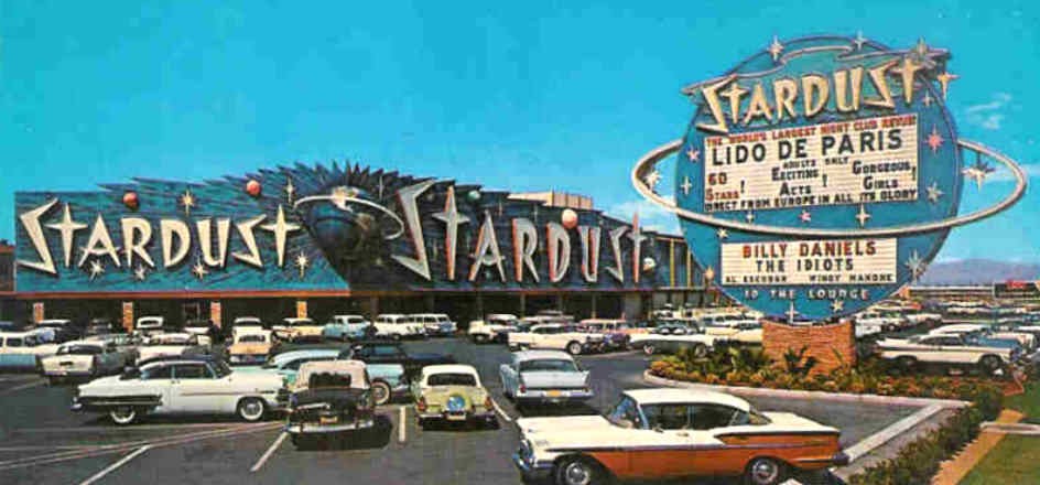 Historic Stardust Hotel & Casino exterior, neon marquee and parked cars in Las Vegas.