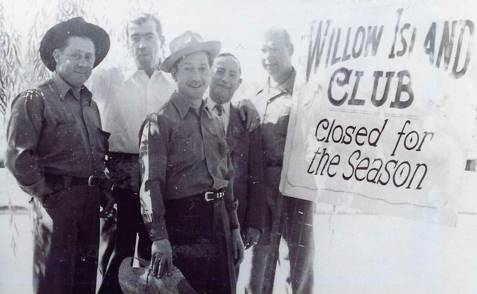 Willow Club Reno crew standing beside a club sign.