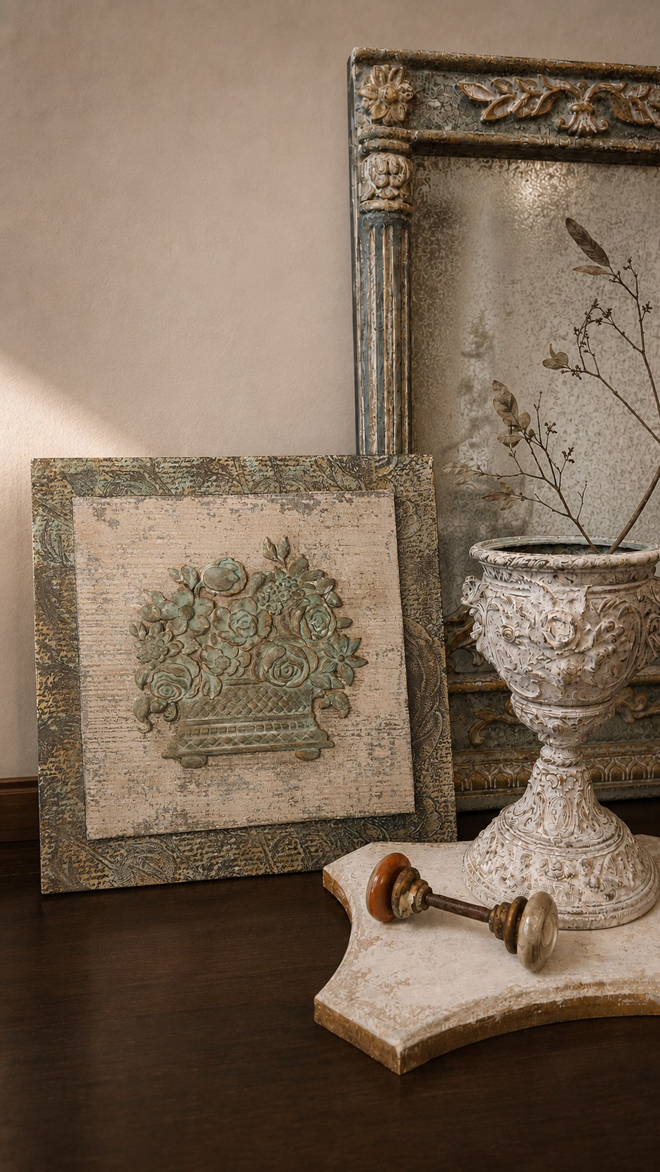 Hand-finished wall art, mirror, and decorative urn in Patricia’s studio