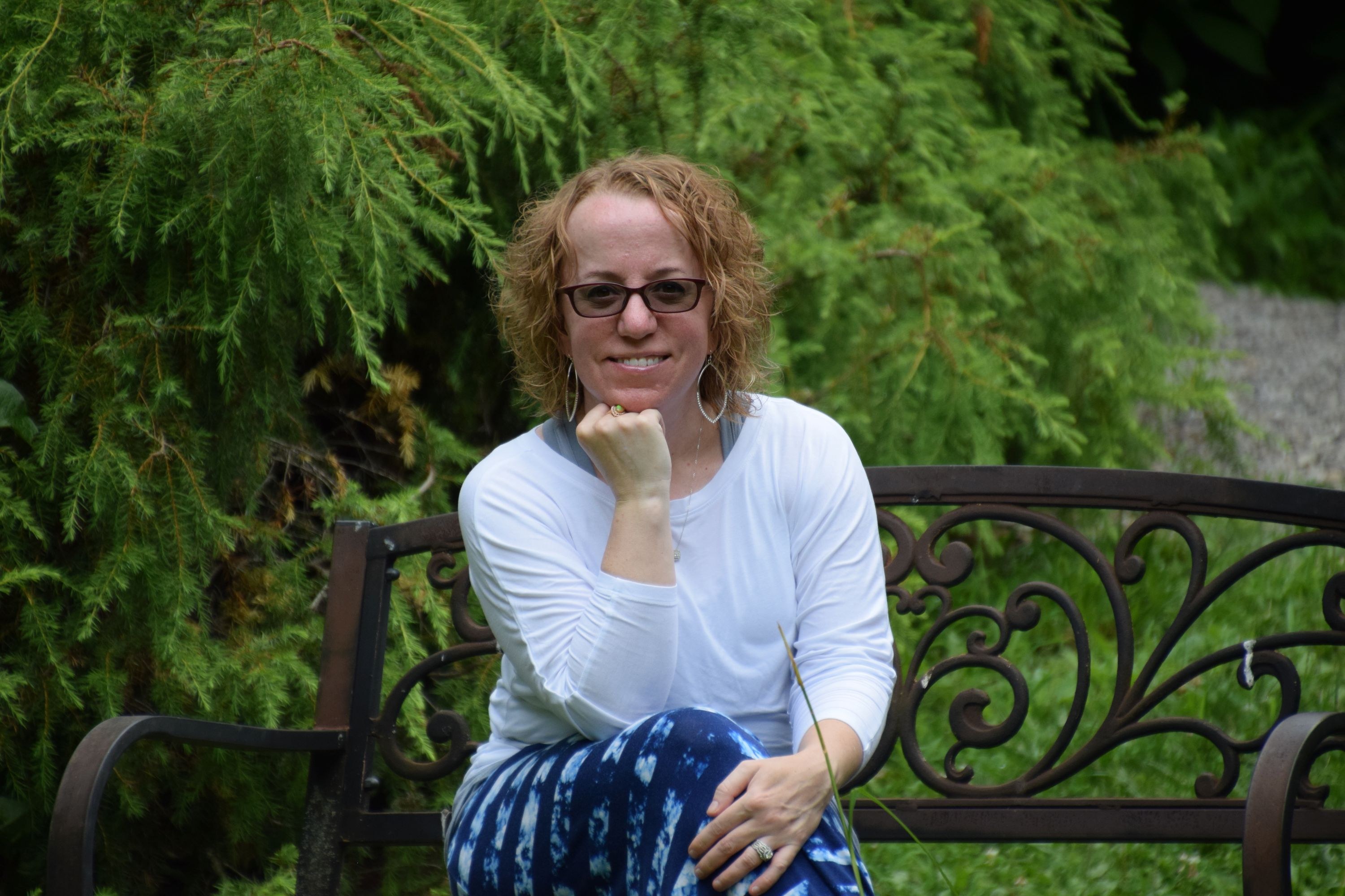 Cori Dickess sitting in a garden