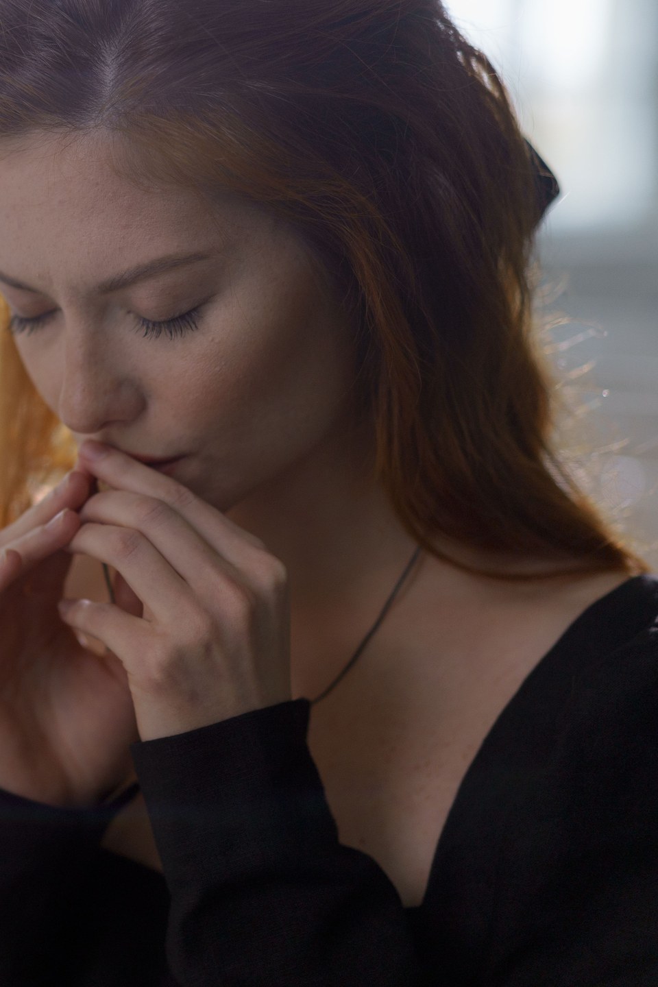 Woman praying quietly in warm morning light